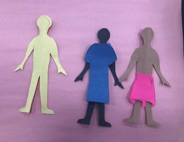 paper dolls cut out of construction paper