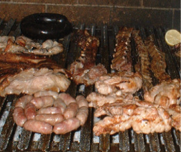 Meat rosting on a large grill.