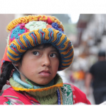 A young gurl in a brightly-colored knit hat.