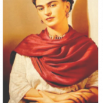 A woman looking serenely, wrapped in a red scarf.