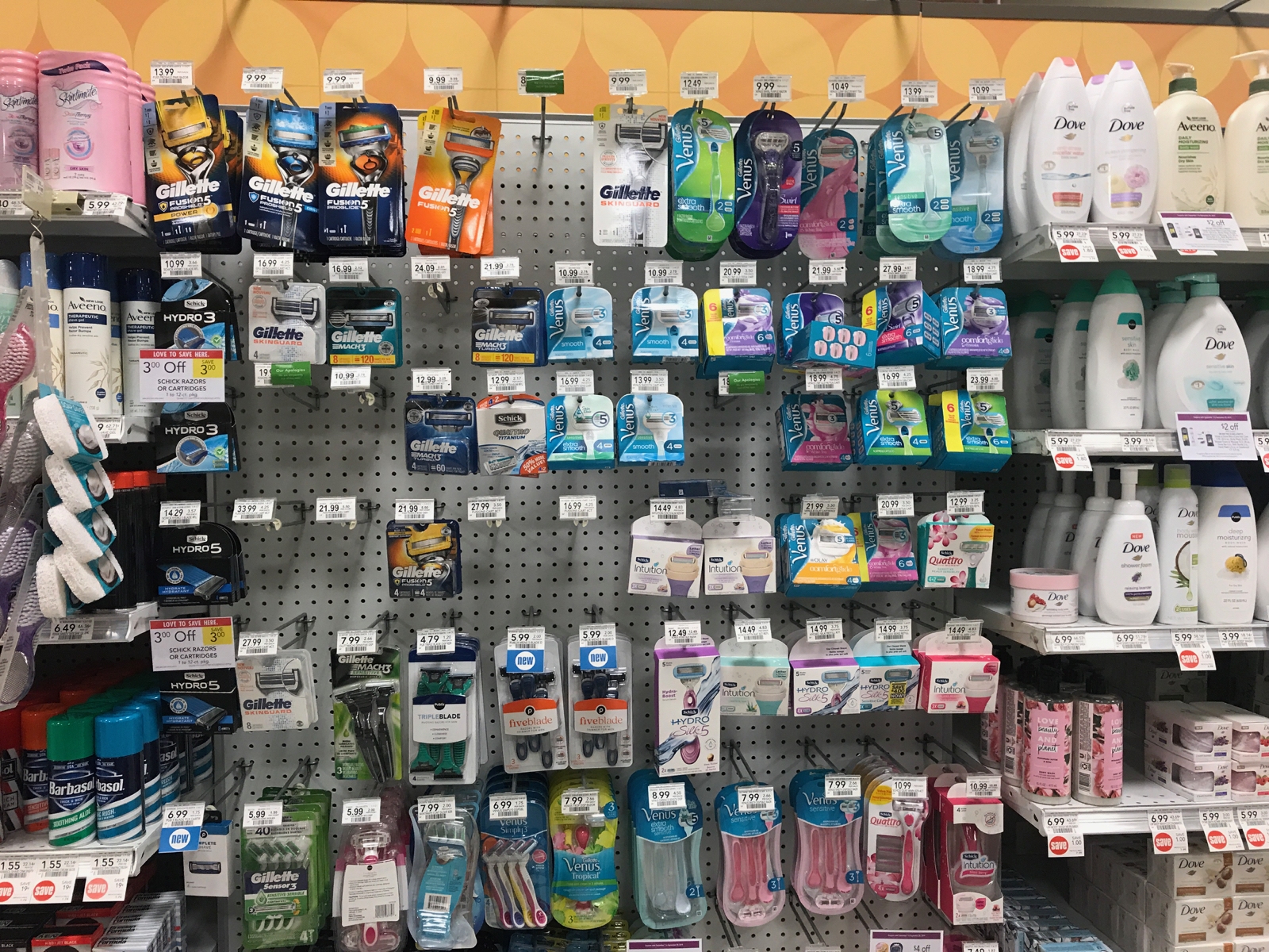 Shelves of products showing clear gender marketing divides; male and female razors that are blue and pink respectively, soap, and other products.