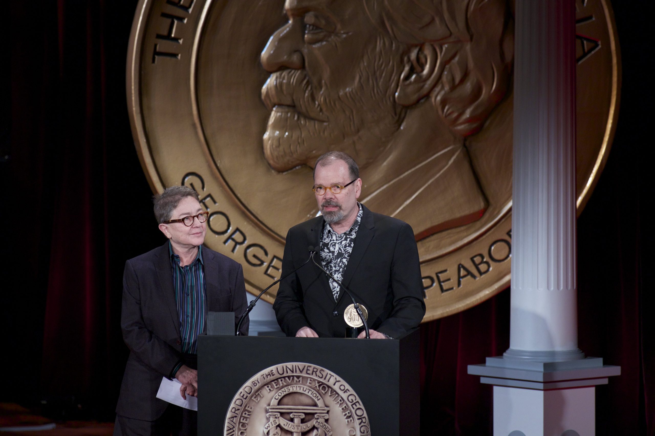 A man speaks from a microphone.