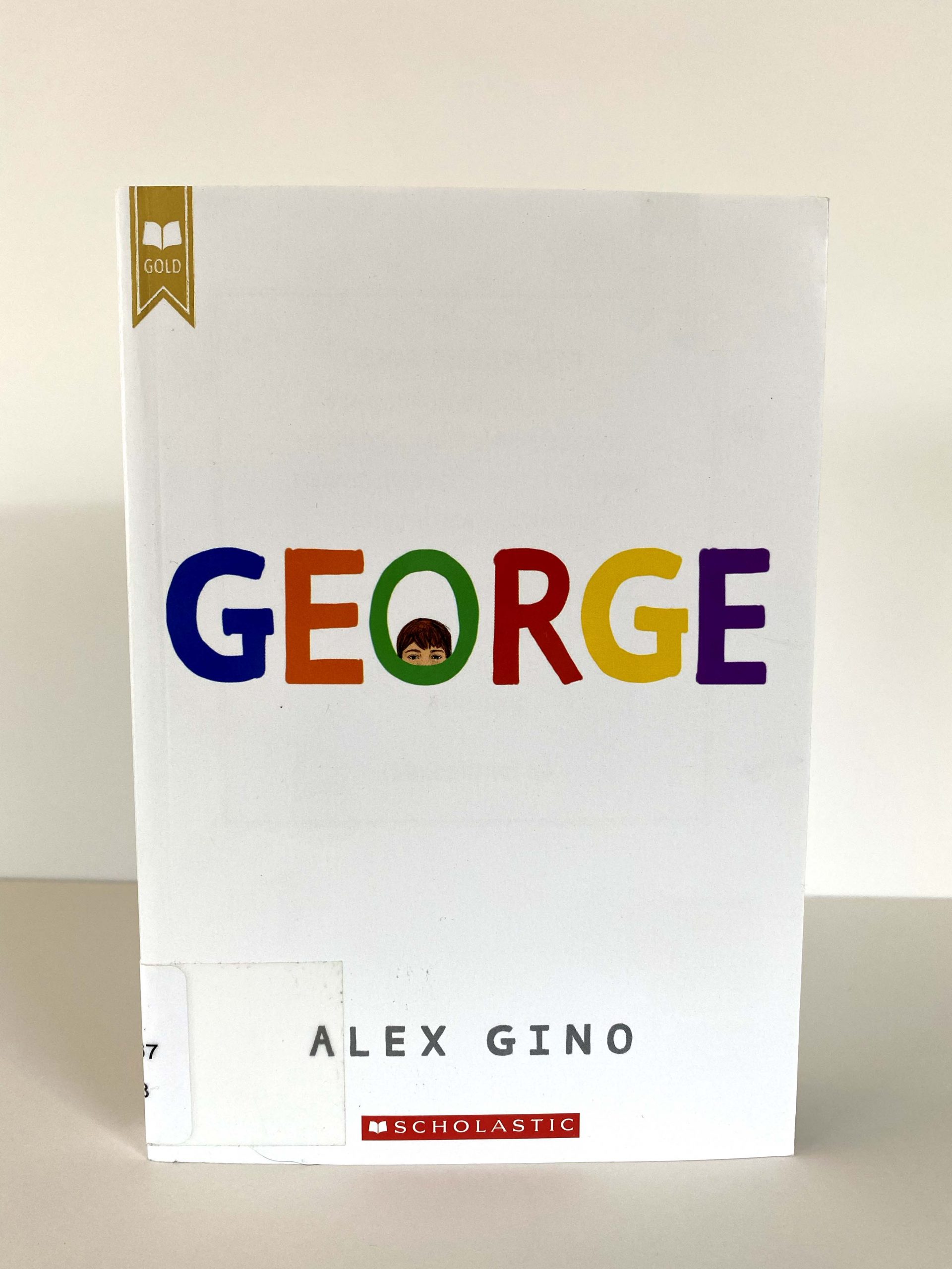 A book with colored letters that say "GEORGE," with a face peaking out from the O.