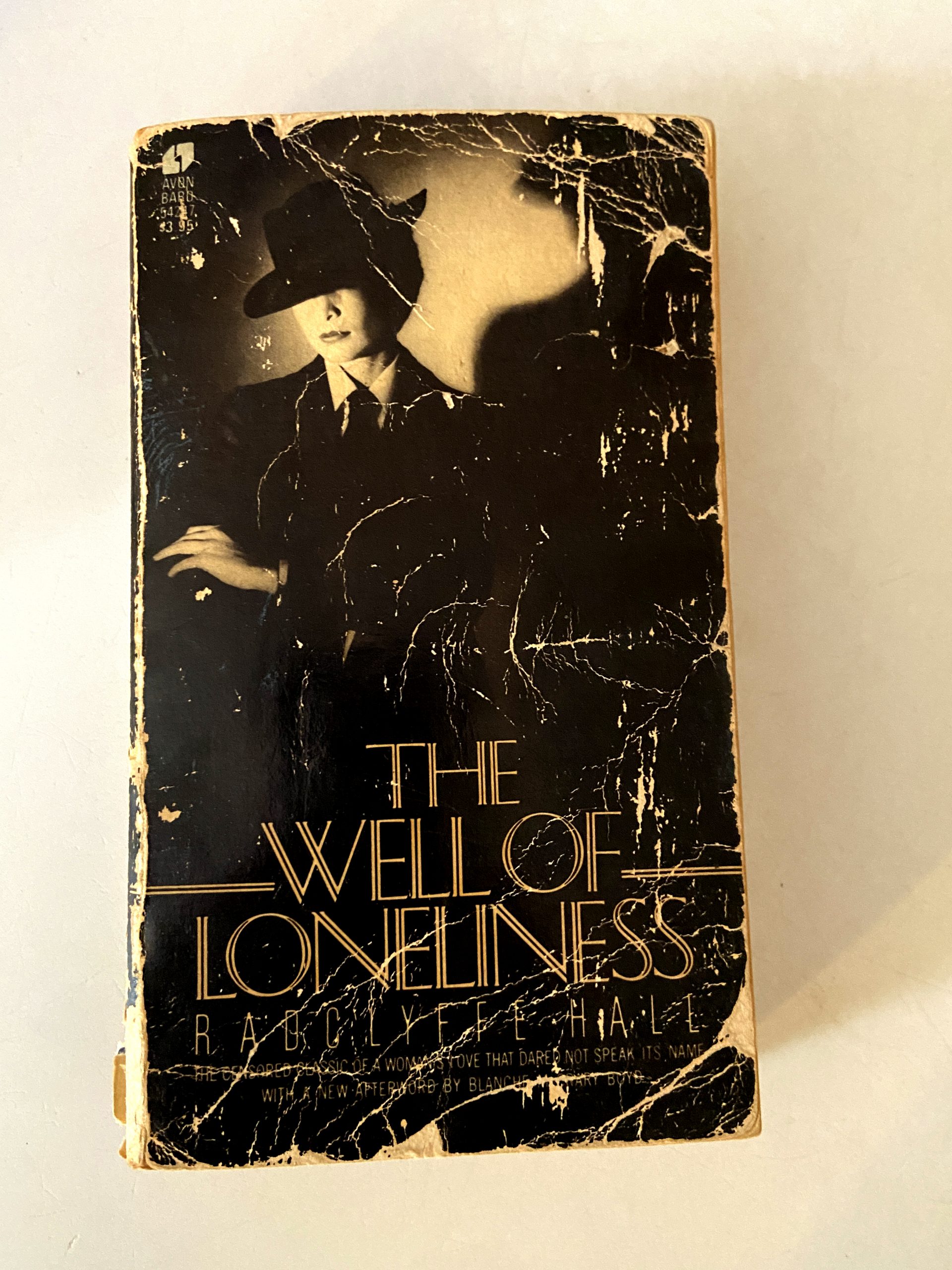 An old book with a half-lit woman in a suit on the cover.