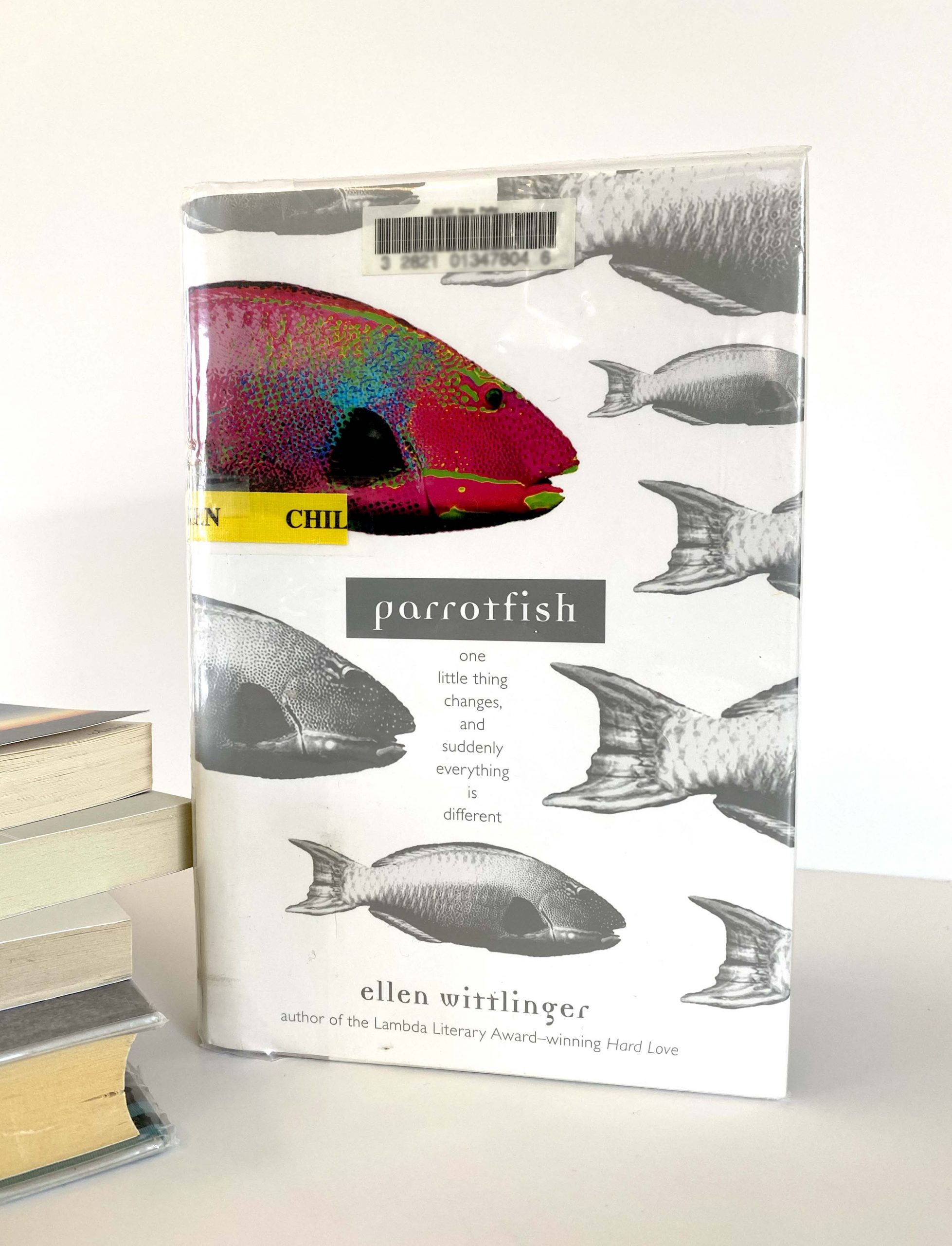 A book with fish on its cover; one is colored-in.