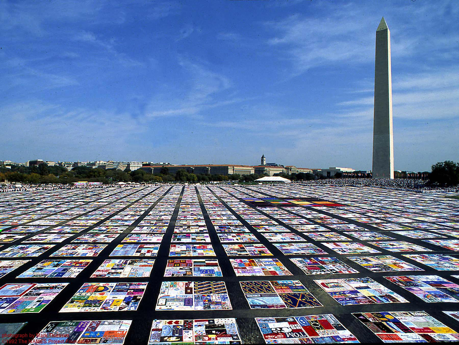 A photo of a large quilt by the Washington Monument.