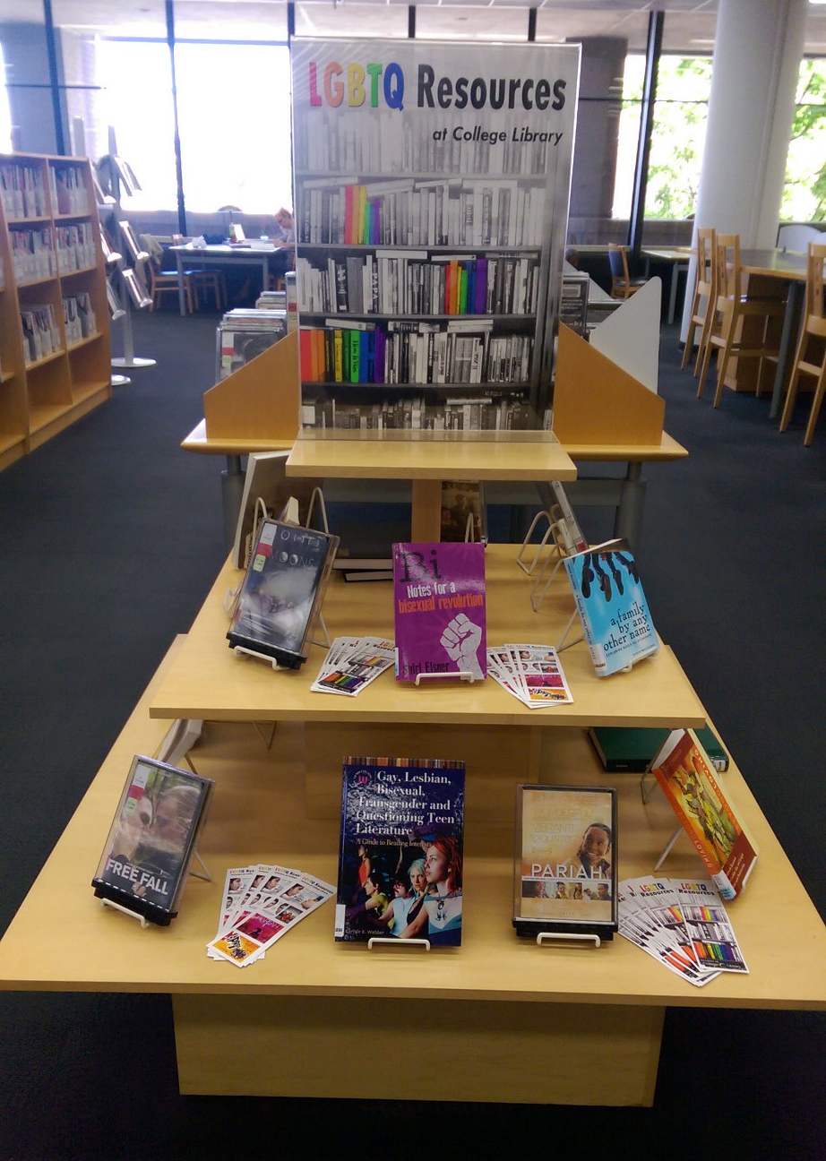 LGBTQ+ books are laid out on a display.
