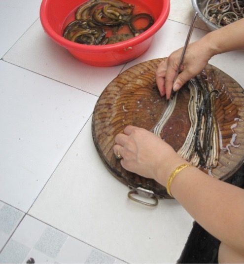 Fish being prepared on a cutting board.