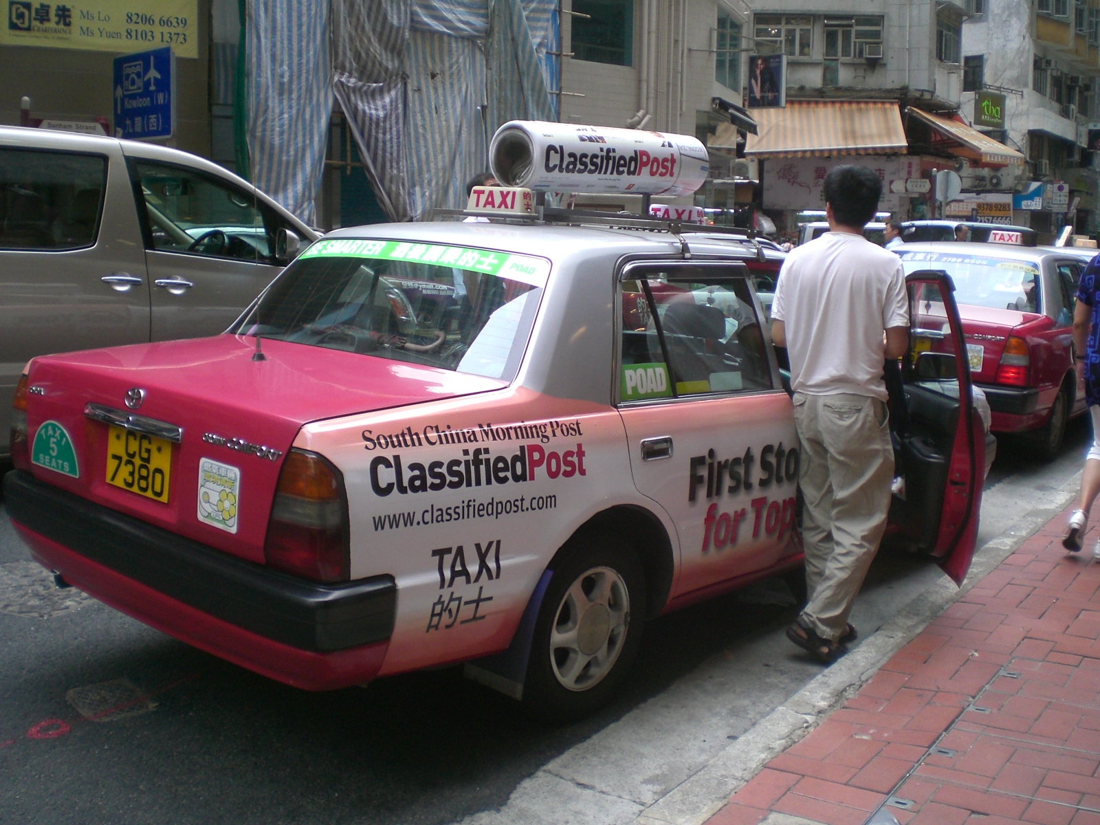 a man entering a taxi