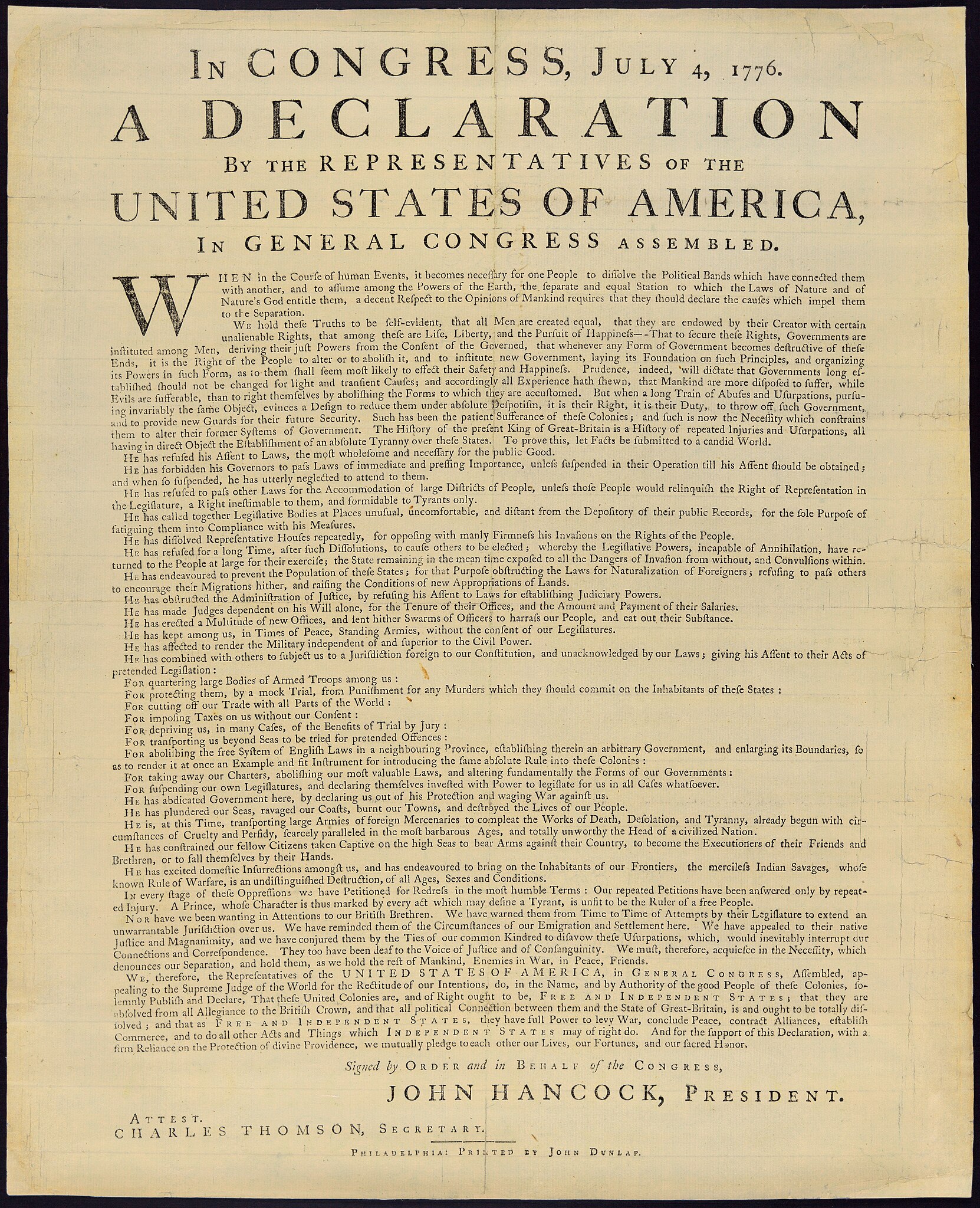 The image shows the original text of the Declaration of Independence, dated July 4, 1776. It features formal and detailed text outlining the colonies' decision to declare independence from Britain. At the bottom, the document is signed "by order and in behalf of the Congress" John Hancock, President, with ornamental script. The document has an aged, historic appearance.