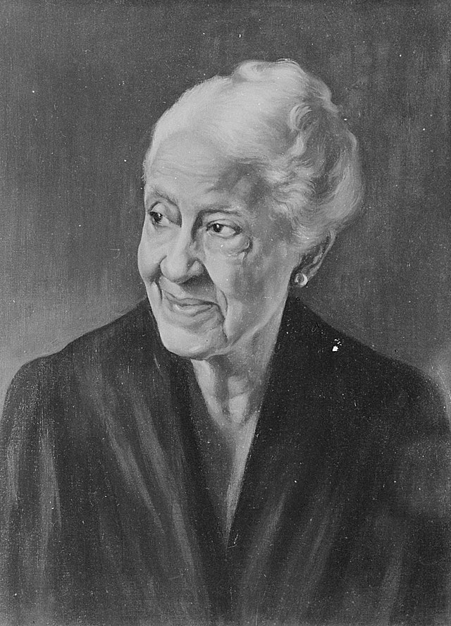 A painting of Mary Church Terrell in her older years with white hair and a gentle smile, gazing to the left. She wears a dark garment and earrings.