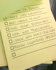 Photograph of a handwritten checklist on yellow paper